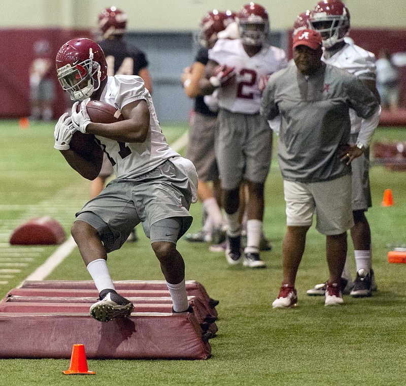 Alabama running back Kenyan Drake (17) works through drills under the watchful eye of Alabama running backs coach Burton Burns during Alabama's spring football practice on April 16, 2015, at the Hank Crisp Indoor Facility in Tuscaloosa, Ala. (Vasha Hunt/AL.com via AP)