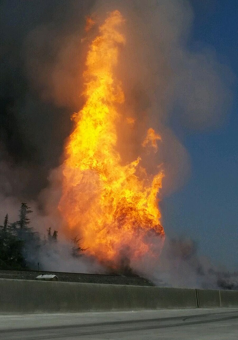 A fireball erupts after a large gas pipeline exploded in Fresno, Calif., Friday, April 17, 2015. The explosion and fire closed both directions of Highway 99, authorities said. (Kevin Ling via AP)