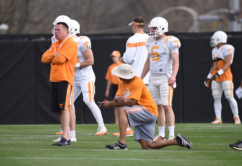Butch Jones, left, watches practice at Haslam Field in Knoxville in this March 31, 2015, photo.