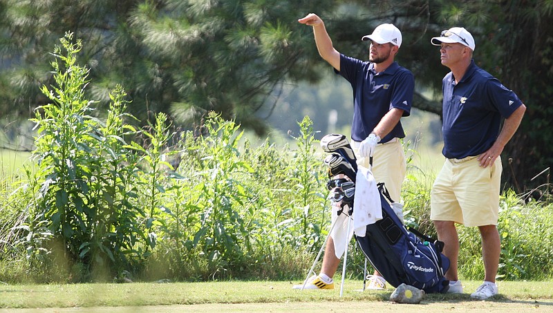 University of Tennessee at Chattanooga golfer Brooks Thomas, left, and head men's golf coach Mark Guhne, discuss Hole 5 from the tee box during the final-round of the Carpet Capital Collegiate at The Farm in this 2013 file photo.