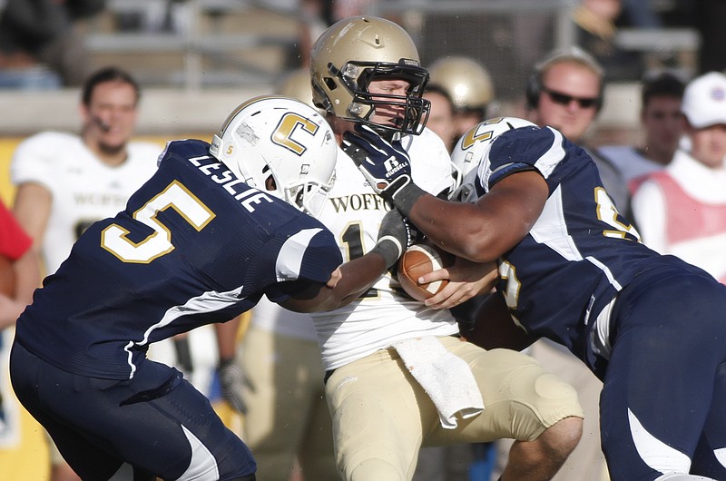 UTC linebacker Nakevion Leslie, left, and defensive lineman Keionta Davis, right, tackle Wofford quarterback Michael Weimer during their game on Nov. 8, 2014, at Finley Stadium in Chattanooga.