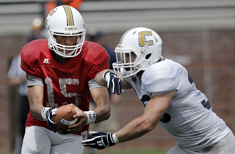 UTC quarterback Alejandro Bennifield hands off the ball to running back Derrick Craine during the Mocs' spring Blue and White football game Saturday, April 18, 2015, at Finley Stadium in Chattanooga. The white team won 6-0.