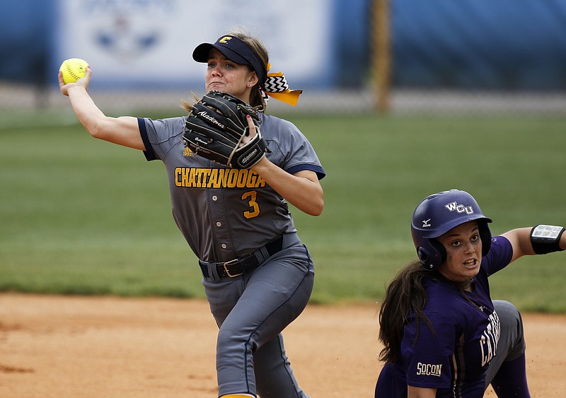 UTC shortstop J.J. Hamill throws to first to try for an out after Western Carolina runner Kara Salvo slid in safe to 2nd during the Mocs' second double-header softball game against Western Carolina on Saturday, April 18, 2015, at Frost Stadium in Chattanooga.