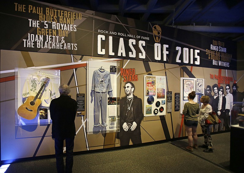 People look at the Class of 2015 exhibit at the The Rock and Roll Hall of Fame and Museum Friday, April 17, 2015, in Cleveland. Ringo Starr, who was previously enshrined with the Beatles in 1988, will be honored along with pop punks Green Day, soul singer-songwriter Bill Withers, underground icon Lou Reed, guitarist Stevie Ray Vaughan and Double Trouble, Joan Jett and The Blackhearts, The Paul Butterfield Blues Band and The "5" Royales. 