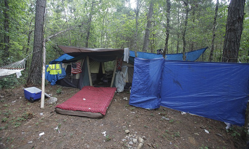 A large tent has had tarpaulins added to it for extra space and privacy in this 2011 file photo of a homeless camp in the East Ridge area.