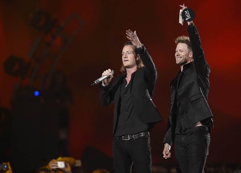 Tyler Hubbard, left, and Brian Kelley, of Florida Georgia Line, accept the award for vocal duo of the year at the 50th annual Academy of Country Music Awards at AT&T Stadium on Sunday, April 19, 2015, in Arlington, Texas.