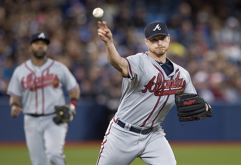 Atlanta Braves starting pitcher Shelby Miller, right, throws out Toronto Blue Jays' Steve Tolleson during sixth inning interleague baseball action in Toronto on Sunday, April 19, 2015. (Darren Calabrese/The Canadian Press via AP)