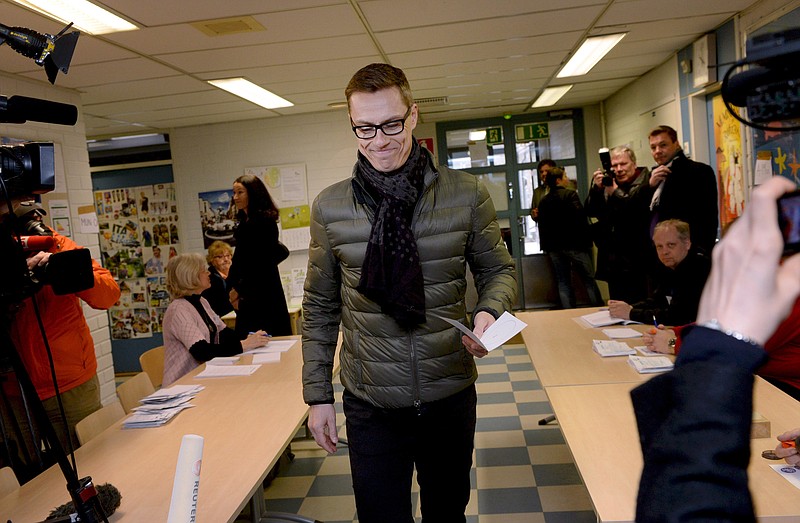 
              Finnish Prime Minister and leader of National Coalition Party Alexander Stubb casts his vote in Espoo, Finland on Sunday April 19, 2015. Finns are voting in parliamentary elections that will determine which coalition of parties can lead the country out of a three-year recession. (Mikko Stig/Lehtikuva via AP) FINLAND OUT, NO SALES
            