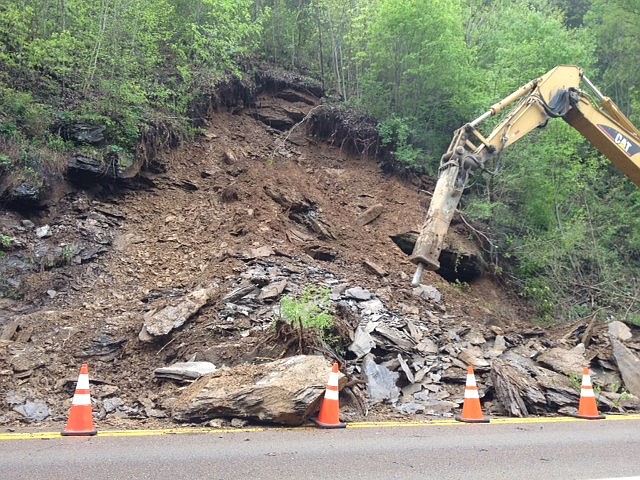 Crew use heavy machinery to clear a landslide of the westbound lane of U.S. Highway 64 in Polk County, Tenn.