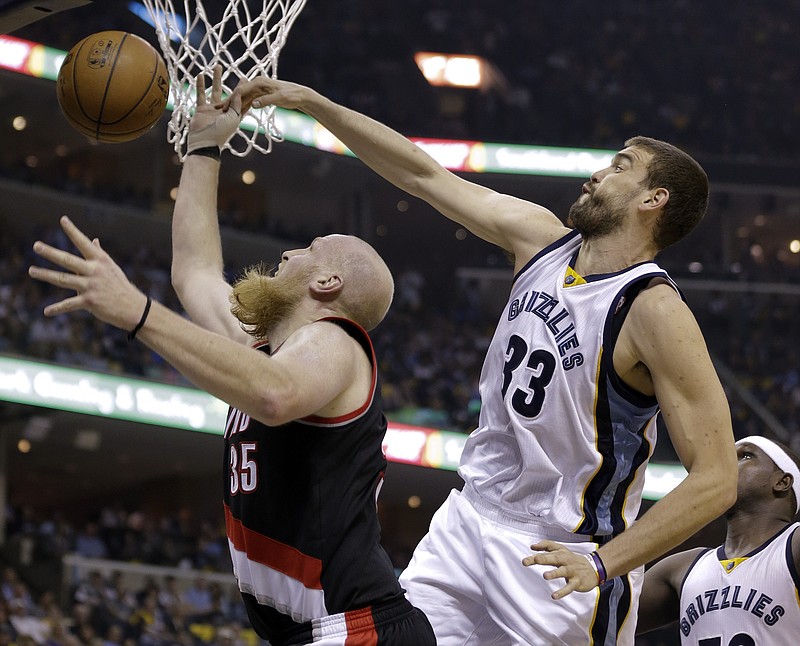 Memphis Grizzlies center Marc Gasol (33), of Spain, blocks a shot by Portland Trail Blazers center Chris Kaman (35) in the first half of Game 1 of an NBA basketball Western Conference playoff series Sunday, April 19, 2015, in Memphis.