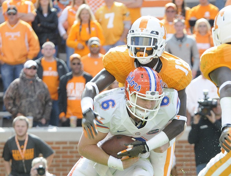Tennessee's Emmanuel Moseley (12) comes over the top of Florida's Jeff Driskel (6) late in their game in this Oct. 4, 2014, file photo.