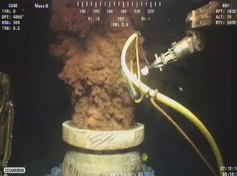 In this Monday July 12, 2010, image from video provided by BP PLC, oil flows out of the top of the transition spool, which was placed into the gushing wellhead and will house a new containment cap, at the site of the Deepwater Horizon oil spill in the Gulf of Mexico.