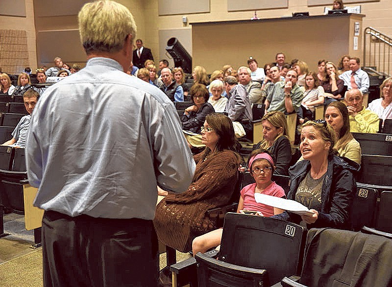 Real estate agent Juliet Jackson, lower right, questions Hamilton County Schools Superintendent Rick Smith during a community meeting at Signal Mountain Middle/High School Monday night.