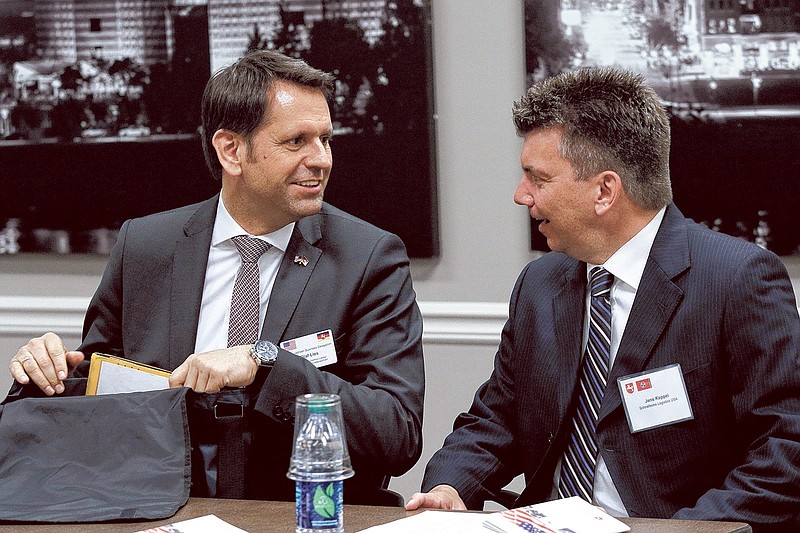 Olaf Lies, Volkswagen AG supervisory board member and Lower Saxony minister of economic affairs, left, talks with Jens Kappei with Schnellecke Logistics USA before a roundtable discussion on economic development at the Chattanooga Area Chamber of Commerce on Tuesday, April 21, 2015, in Chattanooga.