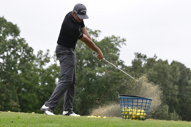 Luke List demonstrates his swing while giving tips to fellow golfers before the L2 Foundation charity golf tournament at the WindStone Golf Club near Ringgold, Ga., on Monday, Sept. 15, 2014.