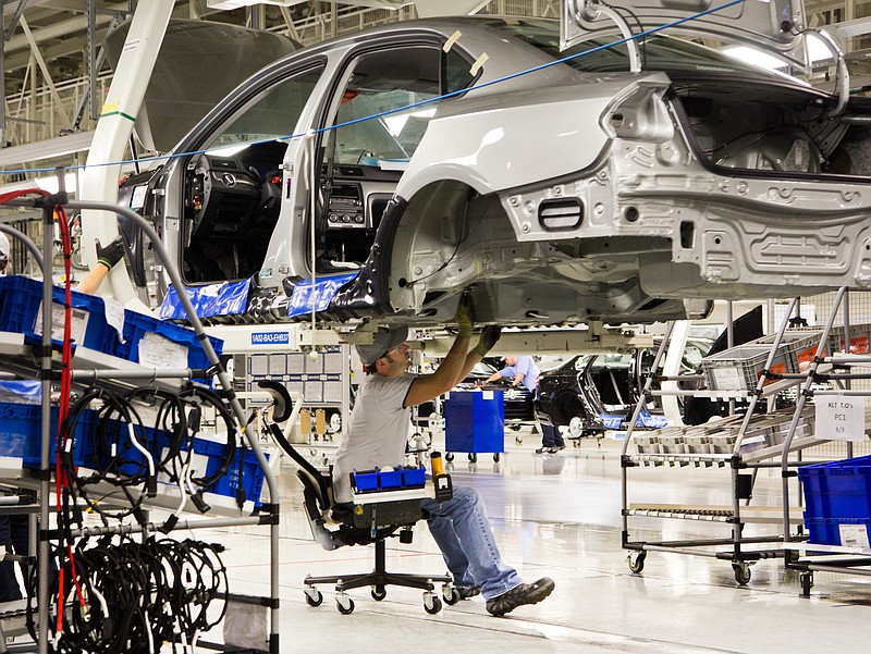 An employee works on a Passat sedan at the Volkswagen plant in Chattanooga in this file photo