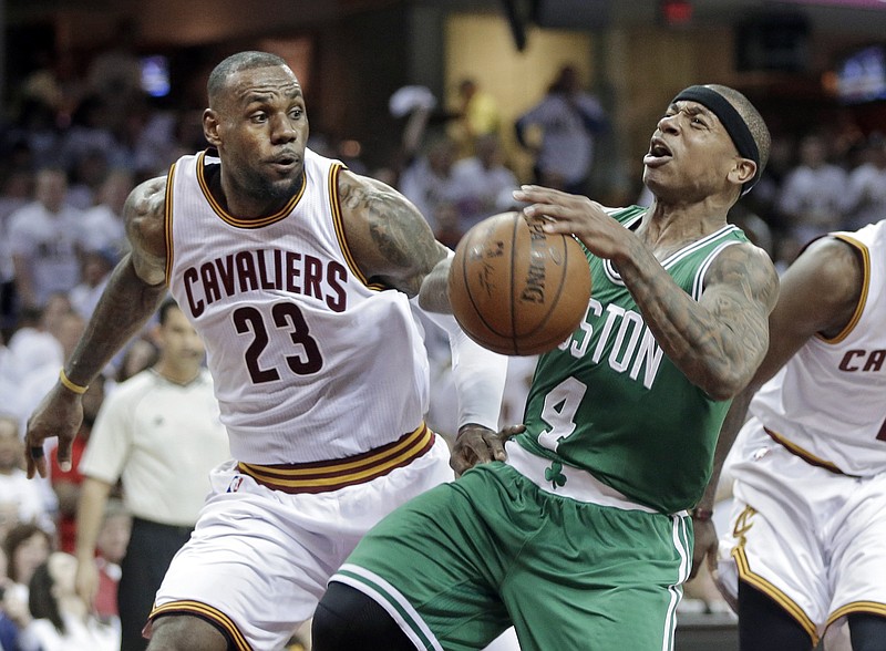 
              Boston Celtics' Isaiah Thomas (4) loses the ball after a foul by Cleveland Cavaliers' LeBron James (23) in the second quarter of a first-round NBA playoff basketball game Sunday, April 19, 2015, in Cleveland. (AP Photo/Mark Duncan)
            