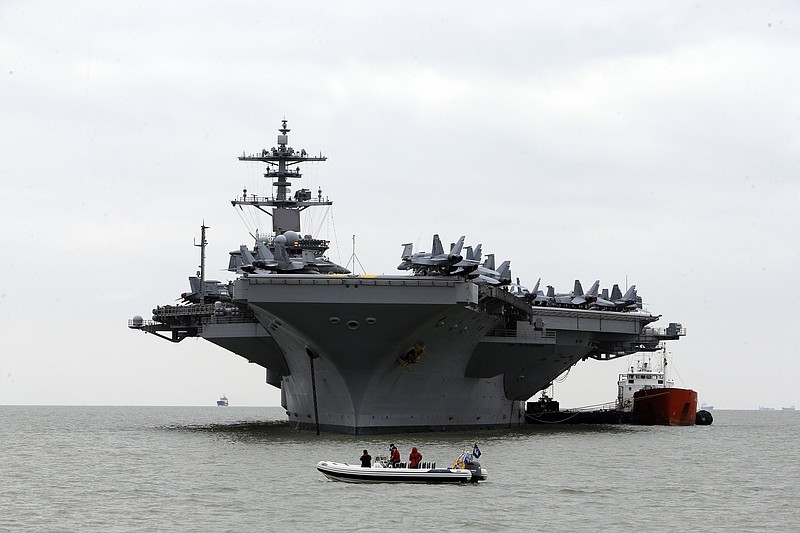 The U.S. aircraft carrier USS Theodore Roosevelt at anchor off the United Kingdom's south coast Monday, March 23, 2015.