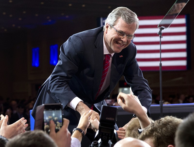 In this Feb. 27, 2015, file photo, former Florida Gov. Jeb Bush shakes hands with people in the audience after speaking at the Conservative Political Action Conference in National Harbor, Md.