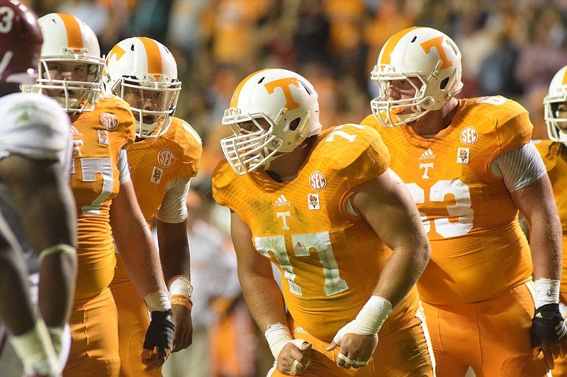 Tennessee quarterback Joshua Dobbs (second from left) calls the play to linemen Mack Crowder (57), Kyler Kerbyson (77) and Brett Kendrick (63) in this 2014 file photo.