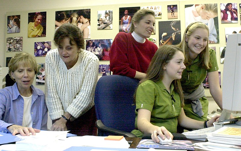 GPS students and teachers (from left) Peggy Michaels, Jane Henegar, Lara Lukens-Smith, Caroline Igou and Kakki Huffaker put the finishing touches on a presentation they are giving to the GPS student body in this 2000 file photo.