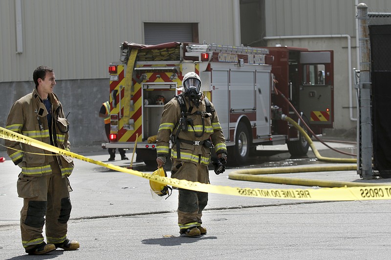 Firefighters work the scene of a fire at the Orange Grove Center's recycling complex Wednesday, April 22, 2015, in Chattanooga.