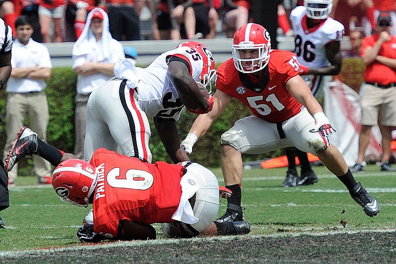 Linebacker Natrez Patrick and Linebacker Jake Ganus combine for a tackleduring Georgia's annual G-Day football game at Sanford Stadium on Saturday, April 11, 2015 in Athens, Ga.









