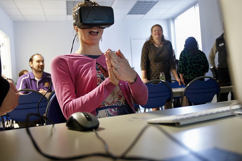 Andree Herbert tries out the Oculus Rift virtual reality device on March 20, 2015, in a classroom at the Tennessee Aquarium IMAX Theatre in Chattanooga. The Oculus Rift is a virtual reality device, and the aquarium is using a development kit version to build VR programming which teaches students about stream ecology conservation.