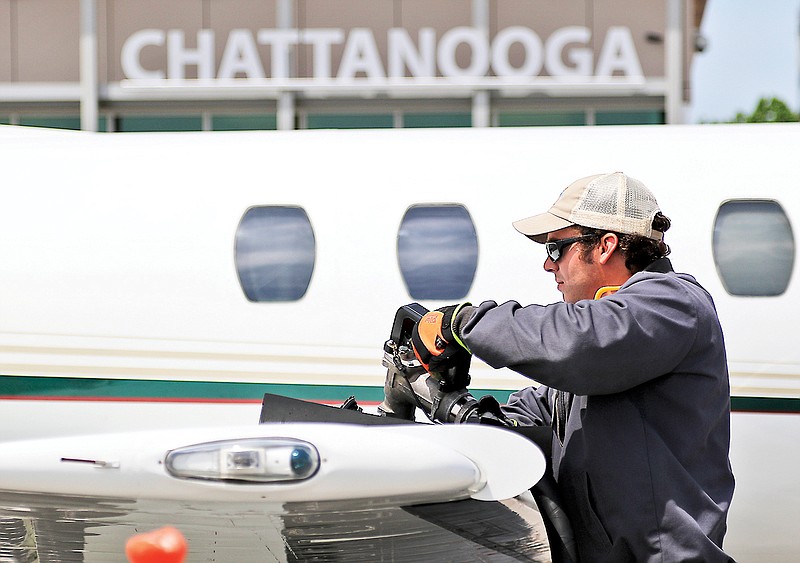 Line technician Patrick Anderson fills a private jet while at the Wilson Air Center on Thursday.