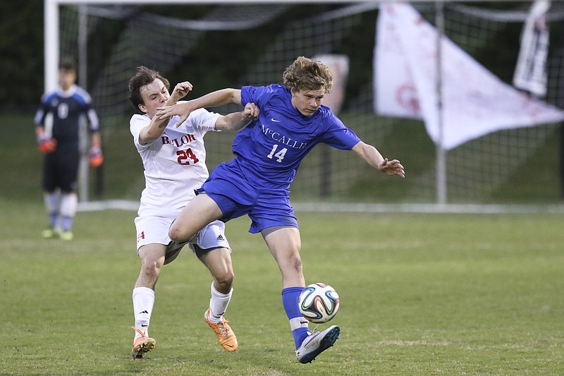 McCallie School's Jonah Bryan (14) battles Baylor School's George Pettway (24) for possession during the rival matchup at the Red Raiders home field on Friday, April 24, 2015. McCallie School won over Baylor with a final score of 2-0.
