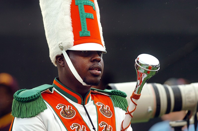 Robert Champion, a drum major in Florida A&M University's Marching 100 band, performs during halftime of a football game in Orlando, Fla., in this 2011 file photo. (AP Photo/The Tampa Tribune, Joseph Brown III, File) 