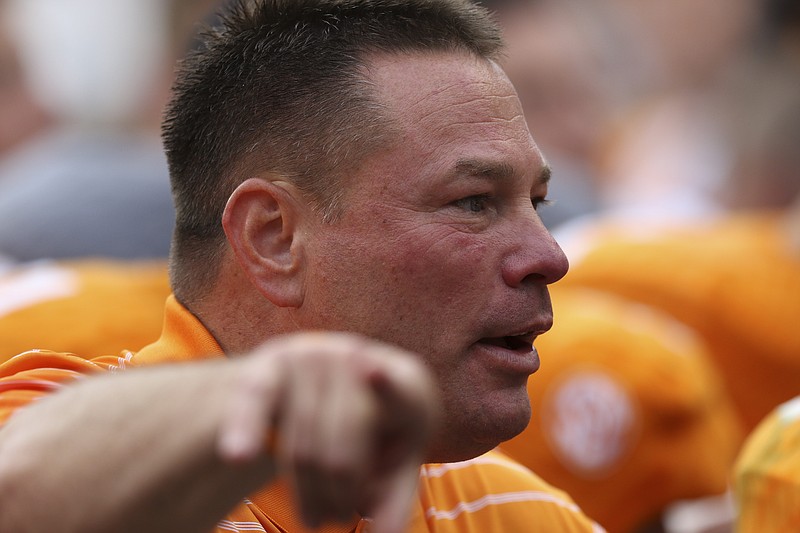 The University of Tennessee's head coach Butch Jones works with his players during the Dish Orange & White Game in Knoxville on Saturday, April 25, 2015. Final score was Orange 54, White 44.