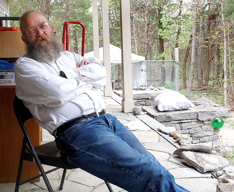 
              In this April 9, 2015 photo, Gary Cantrell speaks during an interview on the front porch of his home in an area north of Bell Buckle, Tenn. Cantrell organizes the Barkley Marathons, which consist of five loops around a 20-mile route, not marked paths, but rough trails through a wooded area. The course includes steep hills. (John I. Carney/Shelbyville Times-Gazette via AP)
            