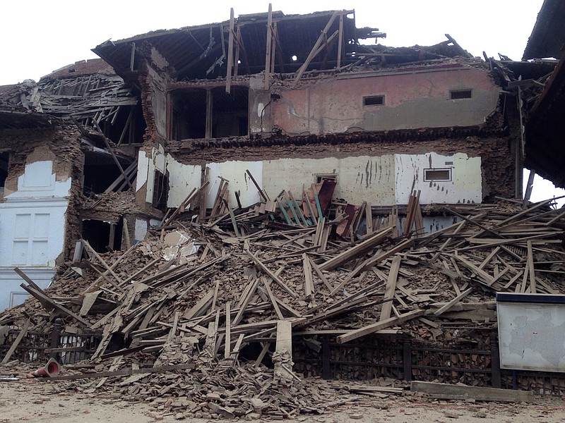 
              A building stands damaged after an earthquake in Kathmandu, Nepal, Saturday, April 25, 2015. A strong magnitude-7.9 earthquake shook Nepal's capital and the densely populated Kathmandu Valley before noon Saturday, causing extensive damage with toppled walls and collapsed buildings, officials said. (AP Photo/ Niranjan Shrestha)
            