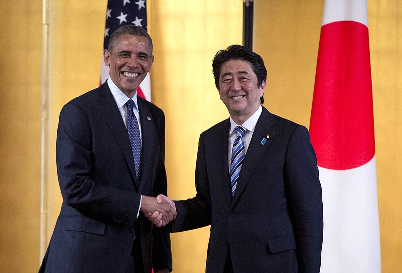
              FILE - In this April 24, 2014 file photo, President Barack Obama shakes hands with Japanese Prime Minister Shinzo Abe as they arrive to participate in a bilateral meeting at the Akasaka State Guest House in Tokyo. Seventy years after the end of World War II, Japan wants to look to the future but can't shake off its past. When Prime Minister Shinzo Abe visits the U.S. next week, he will be promoting a regional free trade pact and stronger defense ties with America as his government loosens the shackles of Japan's pacifist constitution. (AP Photo/Carolyn Kaster, File)
            