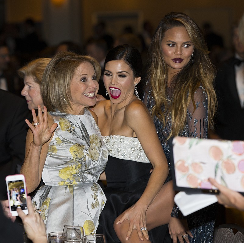 News personality Katie Couric, left, Jenna Dewan-Tatum, center, and model Chrissy Teigen mingle during the White House Correspondents' Association dinner at the Washington Hilton on Saturday, April 25, 2015, in Washington.