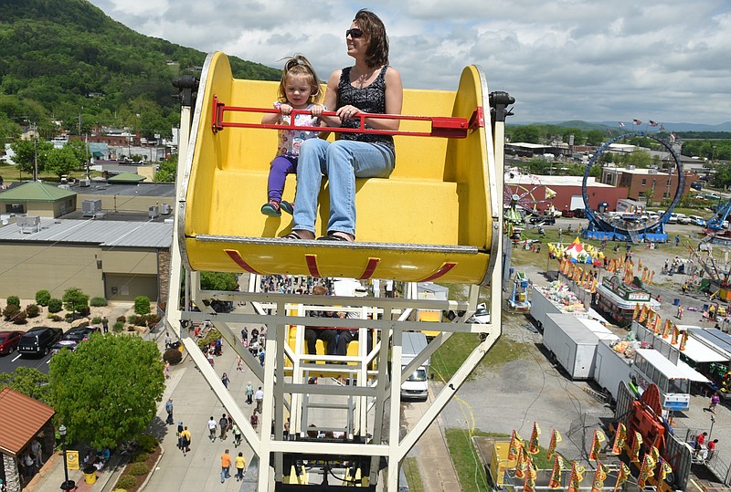 Jennifer Axley rides a ferris wheel with her two-year-old daughter Abigail Axley at the National Cornbread Festival on Sunday, April 26, 2015, in South Pittsburg, Tenn.