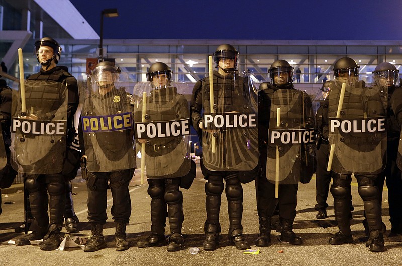 
              Police line a street in downtown Baltimore in response to protests that followed a rally for Freddie Gray, Saturday, April 25, 2015. Gray died from spinal injuries about a week after he was arrested and transported in a police van. (AP Photo/Patrick Semansky)
            