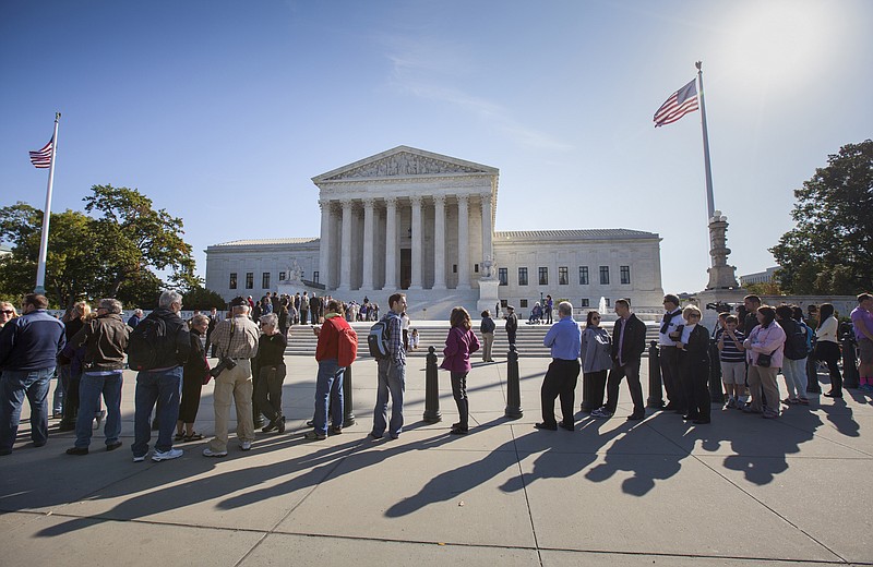 
              FILE - In this Oct. 16, 2014 file photo, people wait to enter the Supreme Court in Washington. Only two years ago, the Supreme Court struck down part of the federal anti-gay marriage law that denied a range of government benefits to legally married same-sex couples. The decision did not address the validity of state marriage bans, but courts across the country, with few exceptions, said its logic compelled them to invalidate state laws that prohibited gay and lesbian couples from marrying. A look at what is now before the Supreme Court, and the status of same-sex marriage around the country.  (AP Photo/J. Scott Applewhite, File )
            
