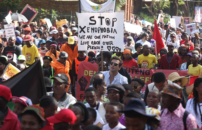 
              Demonstrators walk through the streets of Johannesburg Thursday, April 23, 2015 protesting  against  recent attacks on immigrants that killed seven people. The protesters walked through the center of Johannesburg passing neighborhoods that are home to many immigrants, a large number of whom come from other African countries. (AP Photo/Denis Farrell)
            