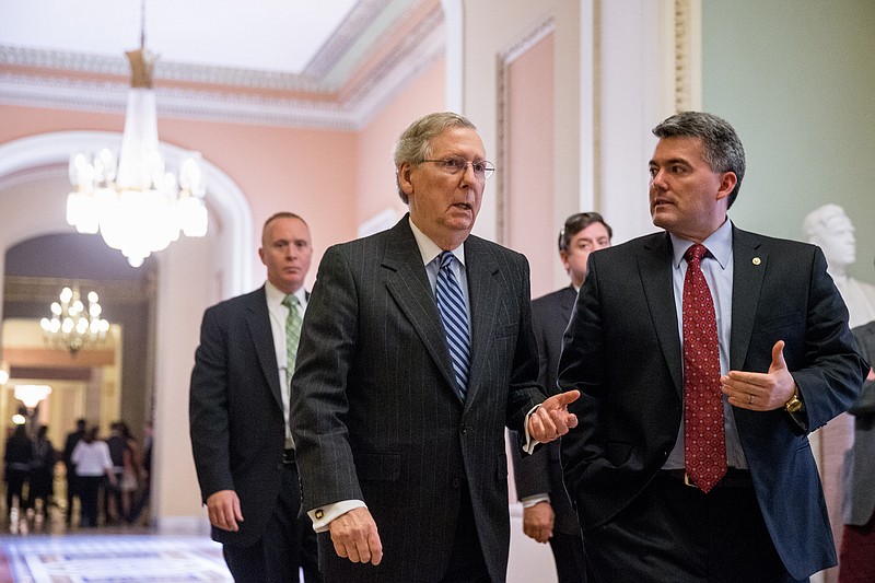 Senate Majority Leader Mitch McConnell of Ky., center, and Sen. Cory Gardner, R-Colo., right, head into the Senate Chamber on April 23, 2015.