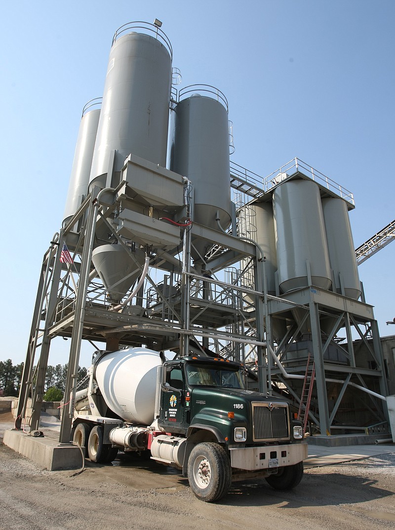 A Sequatchie Concrete Service mixer truck picks up a load of concrete.