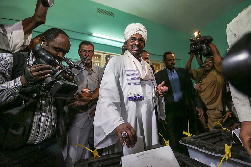 
              FILE - In this Monday, April 13, 2015 file photo, President Omar al-Bashir casts his ballot as he runs for another term, on the first day of the presidential and legislative elections, in Khartoum, Sudan. Al-Bashir won re-election with 94 percent of the vote, according to official results announced Monday, April 27, 2015, extending his 25-year rule despite international war crimes charges and multiple insurgencies. (AP Photo/Mosa'ab Elshamy)
            