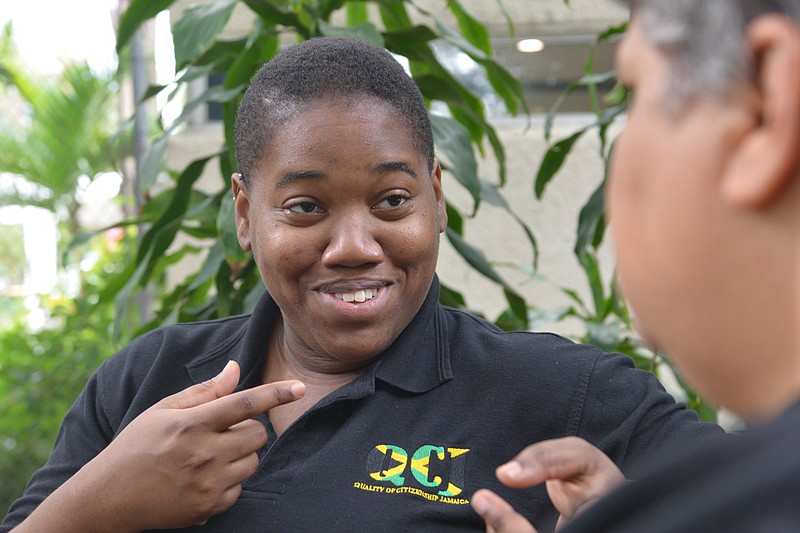 
              In this March 24, 2015 photo, gay rights activist Angeline Jackson, 24, speaks with a colleague in Kingston, Jamaica. Jackson, a victim of a targeted sexual assault when she was 19, now directs the only registered lesbian and bisexual women's organization in Jamaica and is determined to help others recover from sexual crimes targeting female homosexuals, including so-called “corrective rapes” intended to force them into becoming heterosexual or punish them for not fitting societal norms. (AP Photo/David McFadden)
            