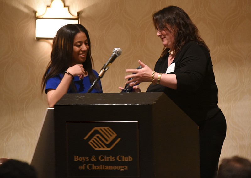 Vinceia Crittenden, 17, receives the first David Fussell Outstanding Leadership Award on Monday at the Boys and Girls Club of Chattanooga fundraising and awards dinner. Presenting the award is Elisabeth Donnovin, vice chairwoman of finance for the organization.