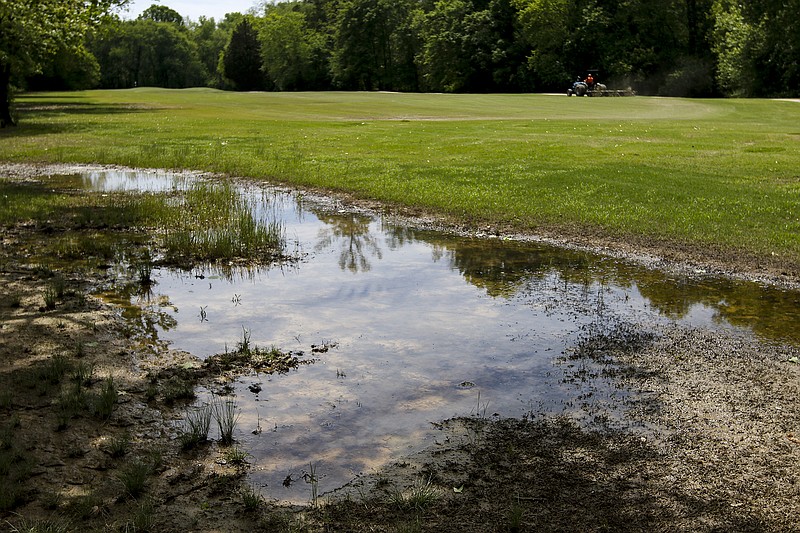 Standing water is visible Tuesday near a fairway of Creeks Bend Golf Course, which was partially underwater after heavy rains.