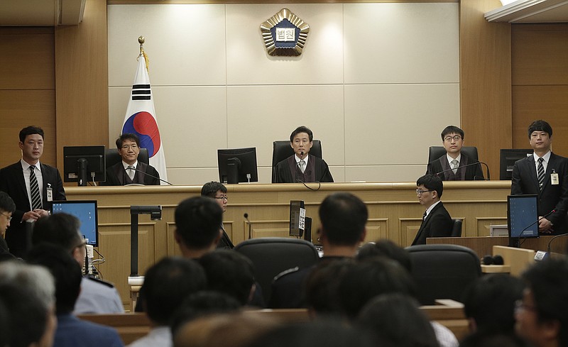 
              Judges sit to preside over verdicts for the sunken South Korean ferry Sewol's crew members who are charged with negligence and abandonment of passengers in the disaster at Gwangju High Court in Gwangju, South Korea, Tuesday, April 28, 2015.  The South Korean appellate court on Tuesday handed down a sentence of life in prison to the captain of a ferry that sank last year, killing more than 300 people. The sentencing is harsher than a November verdict by a district court that sentenced Lee Joon-seok to 36 years in prison for negligence and abandoning passengers in need.  (AP Photo/Ahn Young-joon, Pool)
            
