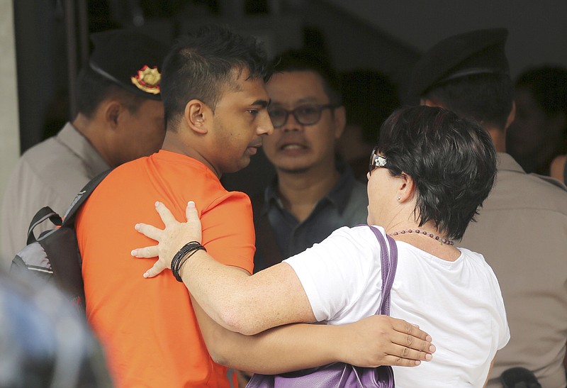 
              Chintu Sukumaran, left, brother of Myuran Sukumaran, an Australian on death row, arrives at Wijayapura ferry port to cross to the prison island of Nusakambangan, in Cilacap, Central Java, Indonesia, Tuesday, April 28, 2015. Indonesia notified nine foreigners and a local man convicted of drug trafficking over the weekend that their executions will be carried out within days, ignoring appeals by the U.N. chief and foreign leaders to spare them. (AP Photo/Tatan Syuflana)
            