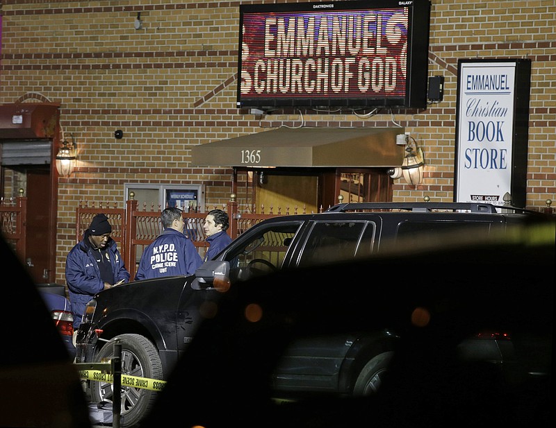 New York City Police Department Crime Scene investigators survey the scene of a shooting outside Emmanuel Church of God in the Brooklyn borough of New York on Tuesday, April 28, 2015. Two people were fatally shot and three people were wounded outside the church where a funeral was taking place at the time.