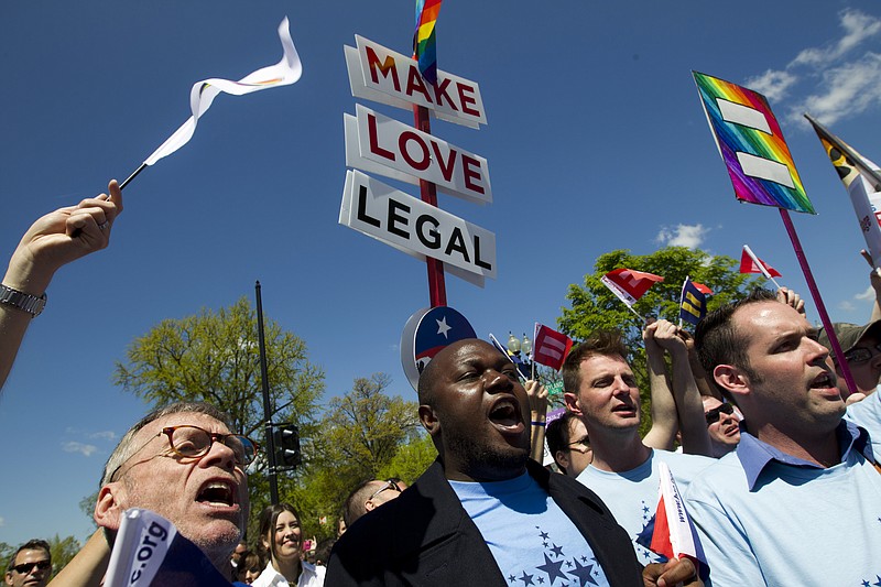Demonstrators rally in front of the Supreme Court in Washington, Tuesday, April 28, 2015, following historic arguments before the court over the right of gay and lesbian couples to marry.